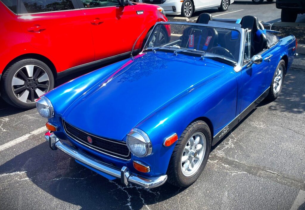 blue MG Midget in a parking Lot
