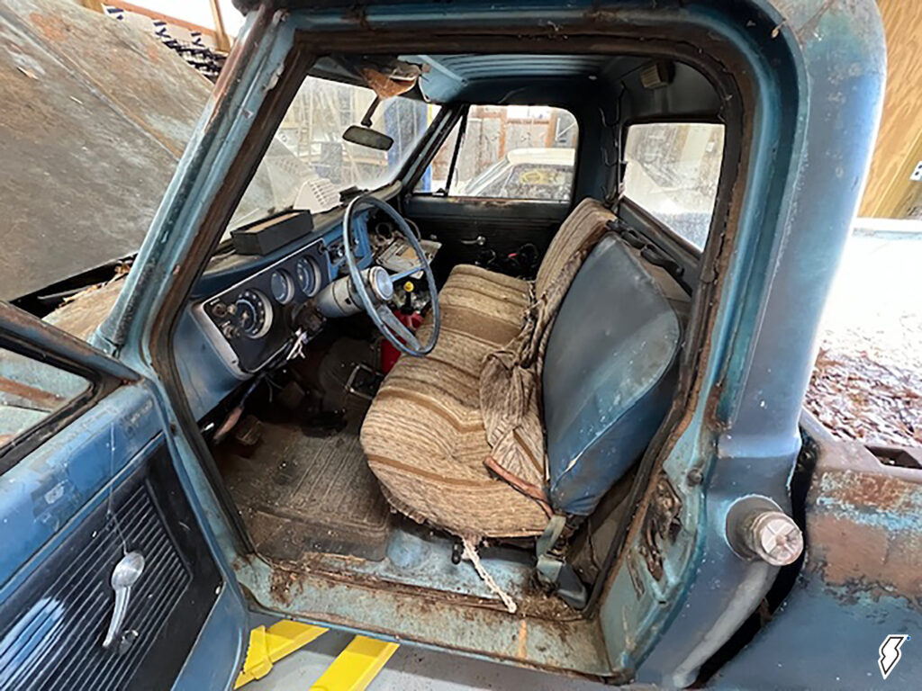 torn up, old cab interior of a chevy truck